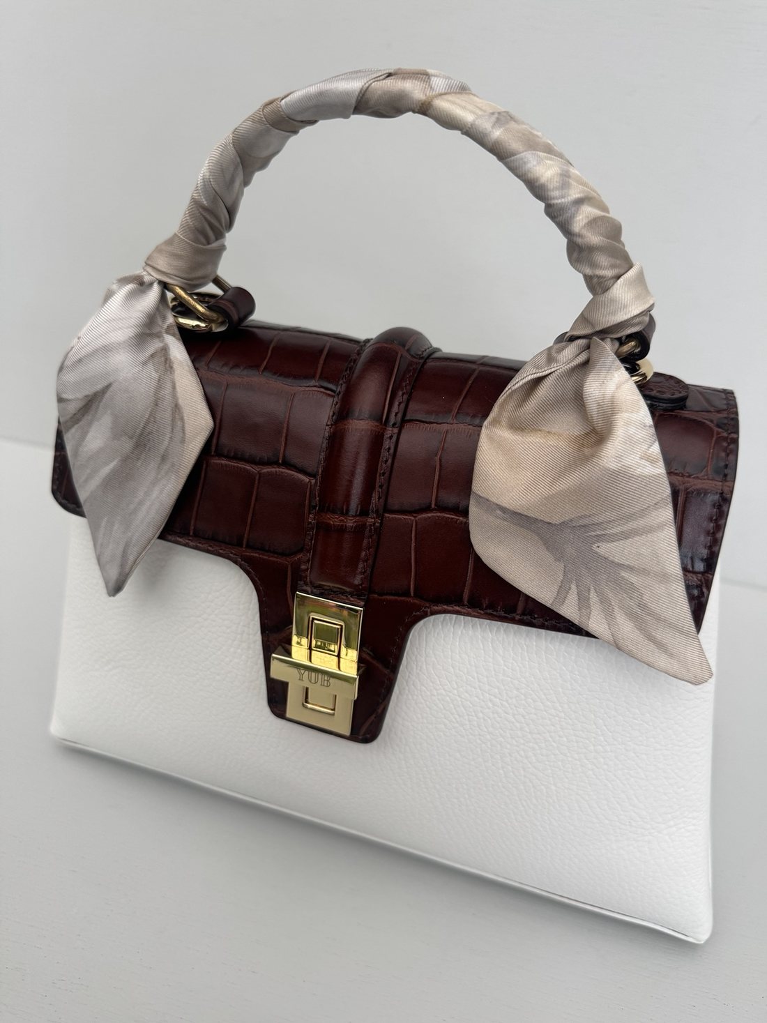 The Monaco, Monaco edition, in white leather with a dark brown crocodile embossed flap and the Monte Carlo twilly wrapped around the handle