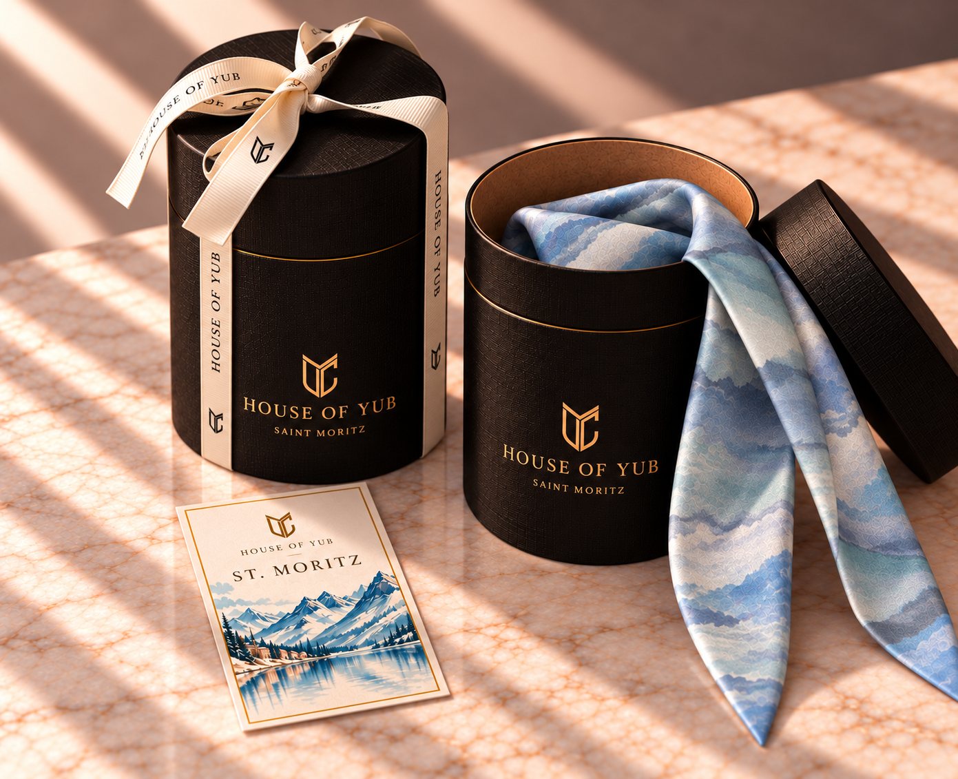 The round black House of YUB twilly box with ribbon and a St. Moritz destination card
